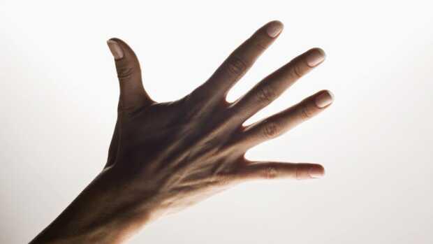 a photo of a hand signifiying five with fingers