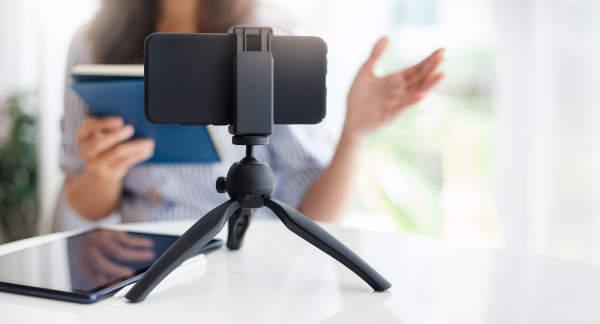 Mobile phone mounted on phone tripod