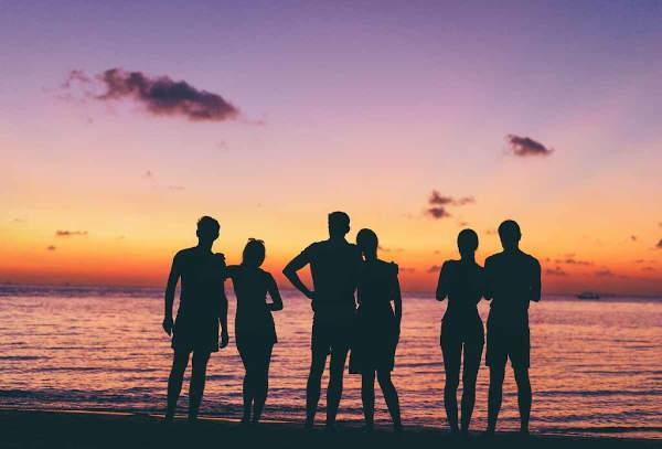 friends at the beach watching sunset